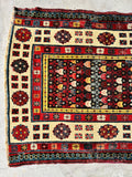 Antique Caucasian hallway runner with geometric borders and an intricate tribal field.