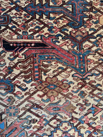 Overhead close-up capturing texture and handwoven detail of the Heriz rug