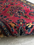 1930s Persian Sarouk rug showing a full view of its heavy, dense wool pile and rich crimson tones.