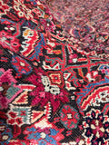 Pink and berry red highlights in Karabagh rug