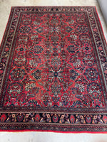 Antique 1920s Persian Bibikabad rug with floral and botanical motifs.
