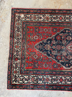 One end view of long antique Persian Bibikabad runner, rare length with strong tribal expression.
