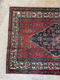 One end view of long antique Persian Bibikabad runner, rare length with strong tribal expression.