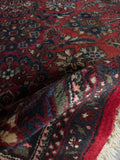 Folded rug border composition with vibrant blues and deep reds.