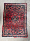 Bidjar rug on floor showing rich color and intricate design.