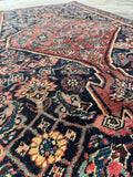 Detail of antique Bidjar rug showing strong wool and geometric floral motifs.