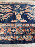 Narrow antique rug for kitchen spaces showing a detailed view of its hand-knotted curvilinear border.