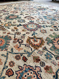 Handwoven rug with intricate paisley and floral patterns.