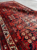 Antique Persian runner showing scattered wear but strong durability.