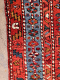 Heavy handle antique wool runner showing the solid construction and traditional edge binding.