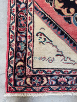 Persian rug border with botanical motifs and ribbon-like patterns.