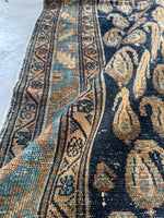 Detailed view of paisley patterns and border bands.
