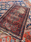1920s antique Lilihan rug small mat displaying a vibrant red botanical floral field (2'2" x 3'4").