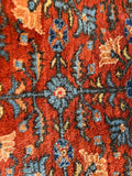 Close-up of botanical lattice design on antique Persian rug.
