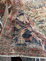 Corner close-up of faded Herati motif on main border band with visible aging.