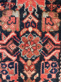 Close up of sturdy wool Persian hall runner highlighting traditional craftsmanship and rich earthy colors.