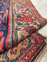 Antique Persian Kurdish wool rug with colorful borders.
