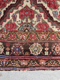 Hand-knotted Bakhtiari gallery rug with camel, blush pink, and dark walnut natural dyes.