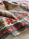 Floppy and pliant antique Caucasian wool rug displaying love-worn texture and natural patina.
