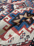 Antique Caucasian Kazak rug with rustic folk art feel and durable wool weave.
