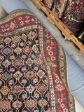 Corner view of vegetable dyed wool antique Caucasian rug with unique tribal motifs.