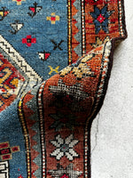 Brick red border rug with alternating eight-pointed stars.