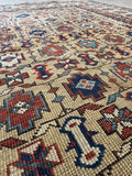Small antique Shirvan rug with all over geometric pattern and ivory ground.