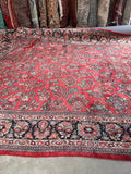 Century-old Persian rug featuring detailed botanical designs and a lustrous lanolin-rich wool pile.