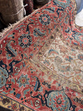 Antique brick-rust ground runner featuring traditional turtle border motifs and faded historic elegance.