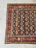 Aged palette antique Caucasian rug with century-old character.