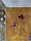 Corner view of low pile Chinese Art Deco rug with butterfly motifs.