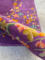 Detail of velvety wool pile on purple field.