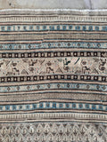 Persian rug border featuring multiple delicate guard bands and tribal motifs.