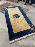 Vintage Chinese floral rug with round central medallion and diagonal corner botanicals.