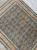 Antique Persian rug Herati design shot highlighting small hand-knotted wool texture and original dyes.