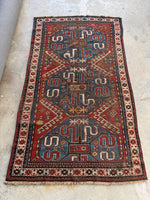 Full view of rare nomadic Cloud Band Kazak rug with graphic patterns.