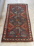 Full view of rare nomadic Cloud Band Kazak rug with graphic patterns.