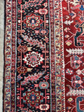 Close up of border band of antique Persian Heriz rug with classic geometric design and impressive 12' x 20' scale.

