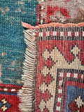 Underside view of authentic Caucasian Kazak wool rug featuring rare border-dominant geometric layout.