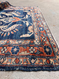 Antique hallway runner close-up focusing on the traditional border work and rich indigo tones.