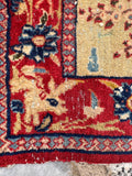 Worn distressed antique Tabriz rug close-up revealing low pile wear, visible warp threads, and century-old character.