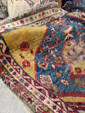 Rare yellow ground Persian rug close-up showing authentic abrash color variations and aged patina.