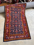 Vintage Persian scatter rug from 1930 with full pile and vibrant natural dyes.