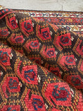 Close up of boteh design on antique Persian tribal runner.