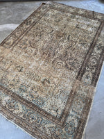 Diagonal view of Persian Lavar Kerman rug in a neutral palette.