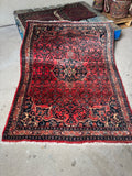 Full view of antique 1940s Persian Bidjar rug with coral abrashed ground.
