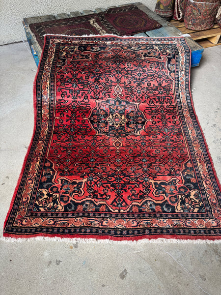 Full view of antique 1940s Persian Bidjar rug with coral abrashed ground.