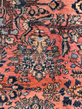 Antique Persian Wool Rug with a rare coral field, floral motifs, handmade craftsmanship, and substantial pile.