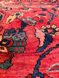 Oversized antique wool rug with beautiful abrash color shifts across the watermelon field.