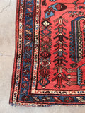 Vintage coral red accent rug with minor antique wear along the outer fringe ends.